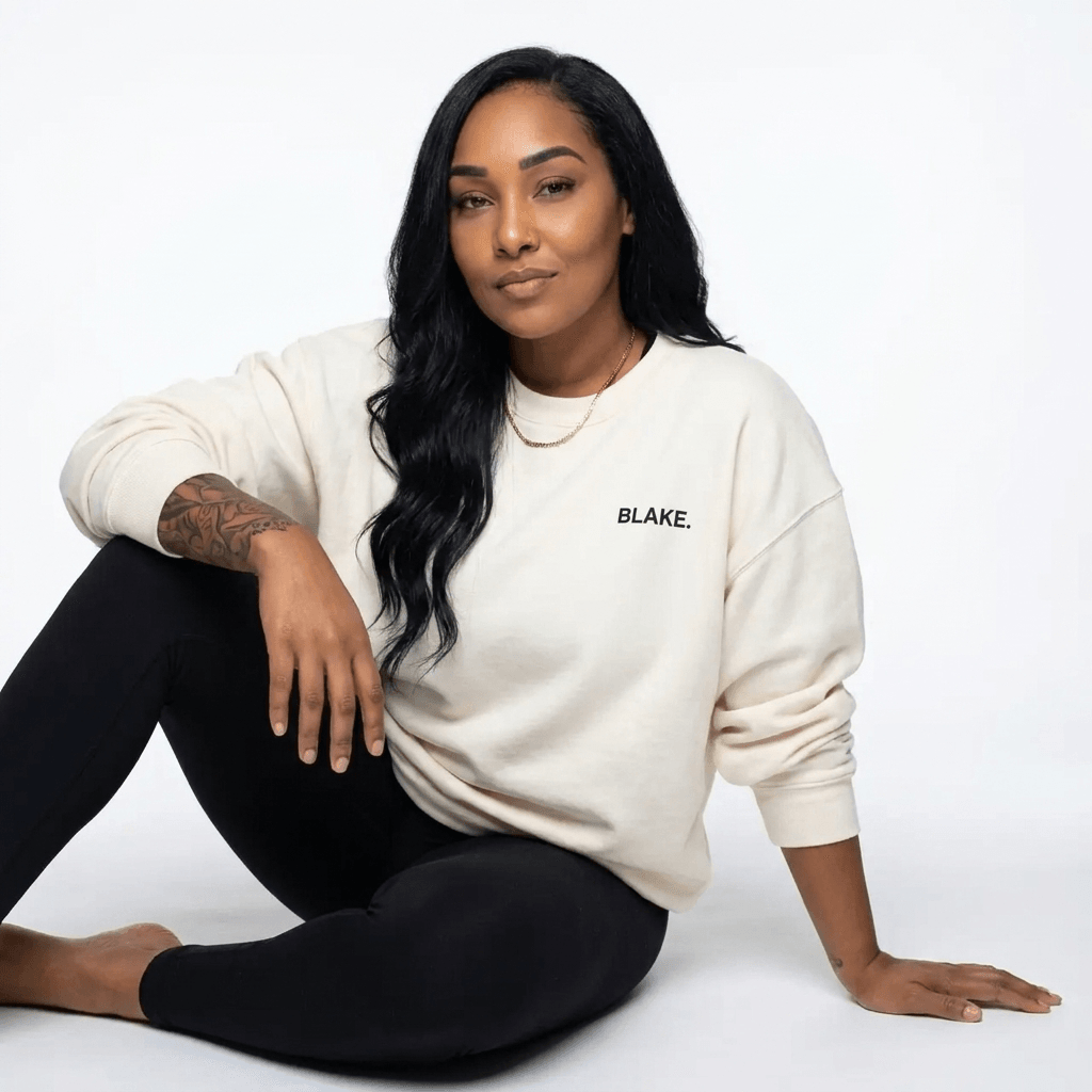 Amanda Howard, founder of Blake, seated in a cream BLAKE. sweatshirt